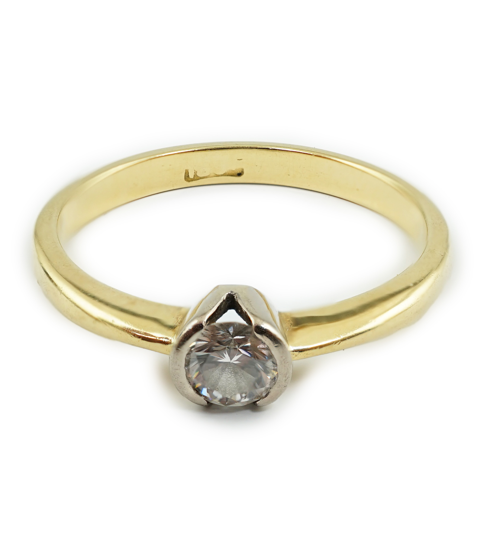 A modern 18ct gold and solitaire diamond set ring